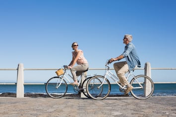 older couple enjoying a bike ride