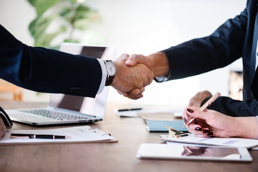 handshake relationship with financial advisor in business